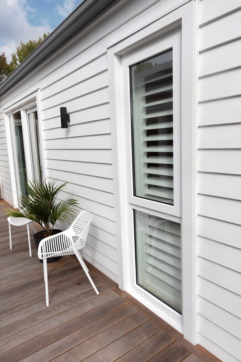 Exterior close-up of the white uPVC window against white weatherboards.