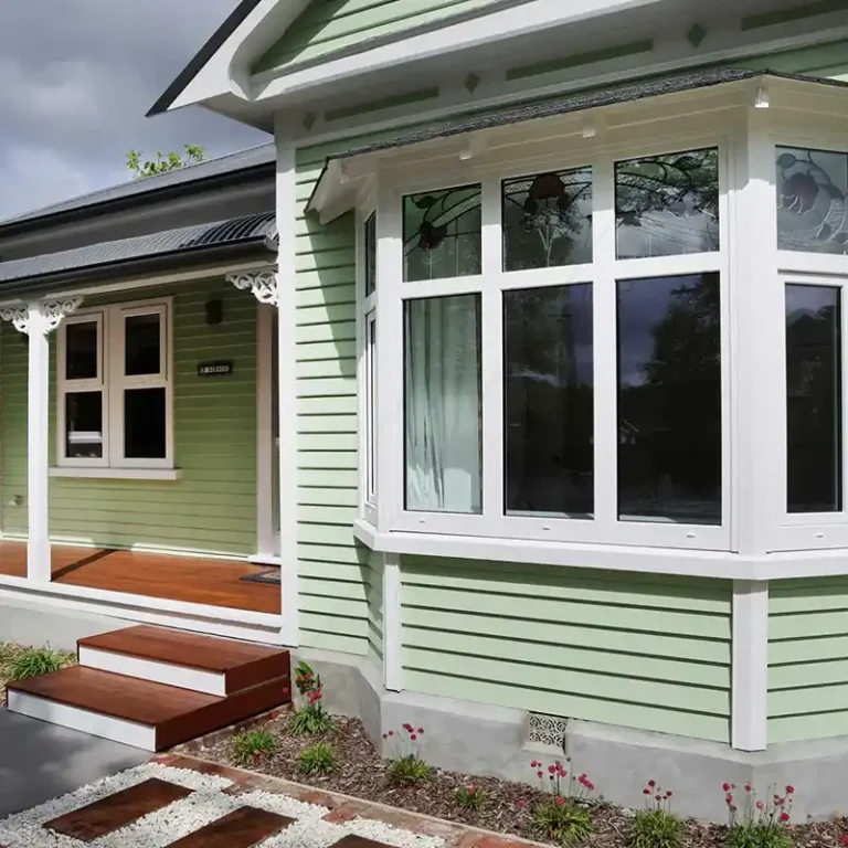 Bay window detail on green villa exterior Christchurch NK Windows installation