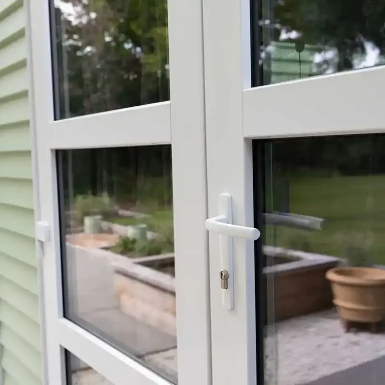 Close-up of white aluminium door handle NK Windows Christchurch installation