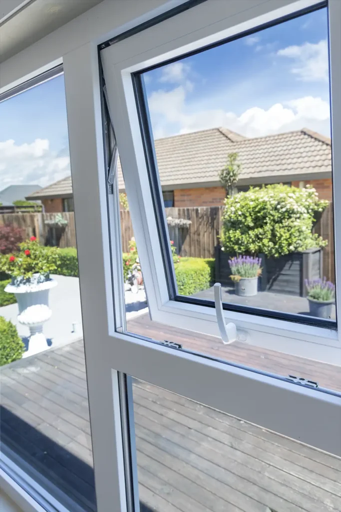uPVC awning window open inside villa showing garden view and outdoor decking Christchurch