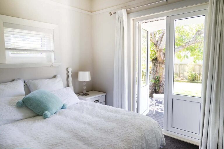 Bedroom with a white uPVC glazed door opening onto the garden.